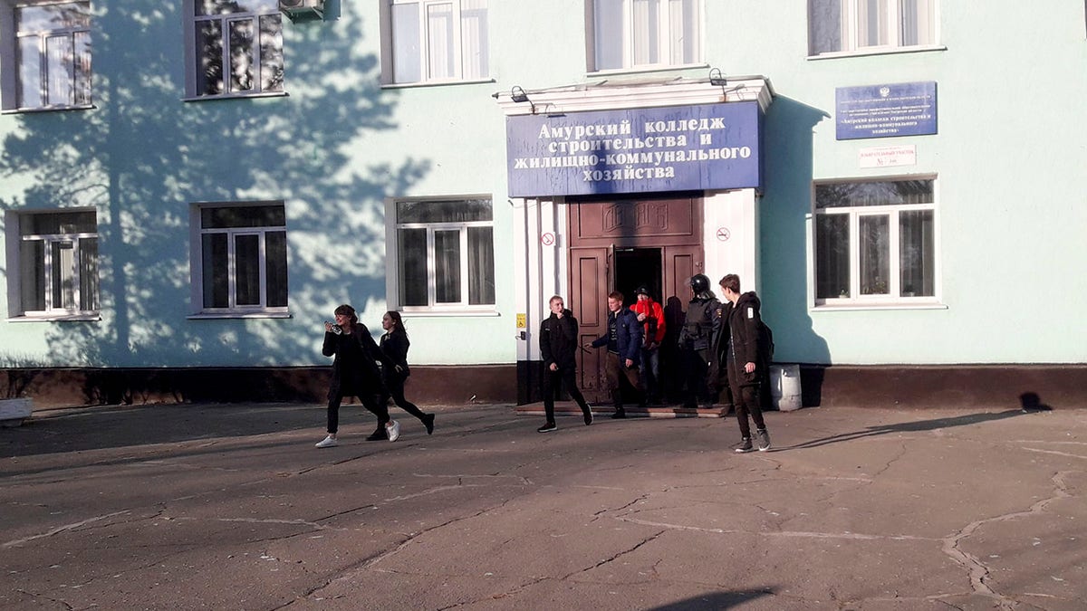 In this photo provided by Vera Zaderko, students leave a college after a shooting in Blagoveshchensk, Russia, Thursday, Nov. 14, 2019. (Associated Press)