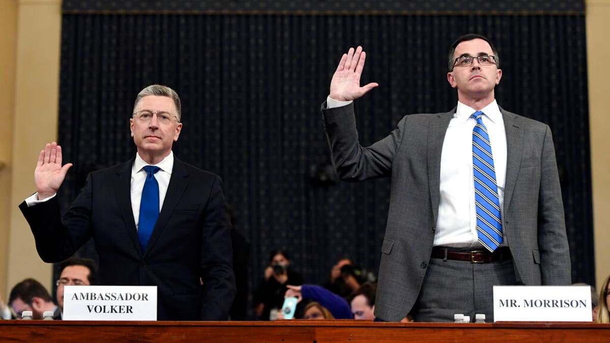 Ambassador Kurt Volker, left, former special envoy to Ukraine, and Tim Morrison, a former official at the National Security Council are sworn in to testify before the House Intelligence Committee on Capitol Hill in Washington, Tuesday, Nov. 19, 2019, during a public impeachment hearing of President Donald Trump's efforts to tie U.S. aid for Ukraine to investigations of his political opponents.(AP Photo/Susan Walsh)