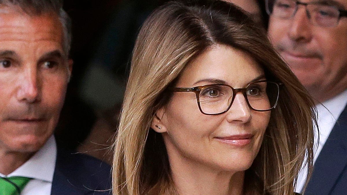 ​​​​​​​Actress Lori Loughlin, front, and husband, clothing designer Mossimo Giannulli, left, leave federal court in Boston after facing charges in a nationwide college admissions bribery scandal, April 3, 2019. (Associated Press)