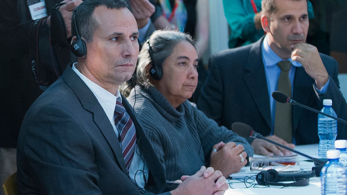 FILE - In this March 22, 2016 file photo, Jose Daniel Ferrer, from left, Juana Mora Cedeno, and Antonio Rodiles, listen during their meeting with President Barack Obama at the U.S. Embassy, in Havana, Cuba. (AP Photo/Pablo Martinez Monsivais, File)