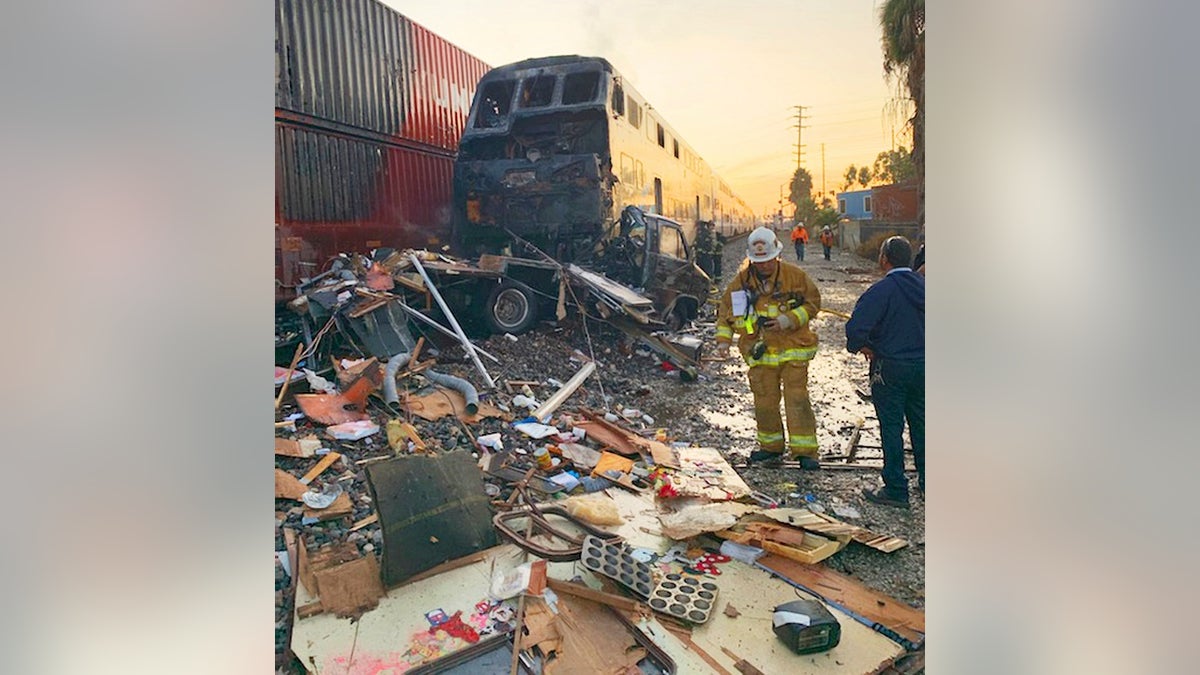 This photo provided by the Norwalk Sheriff's Station shows first responders at the scene after an RV was hit by a commuter train in Santa Fe Springs, Calif., on Friday. (Norwalk Sheriff's Station via AP)