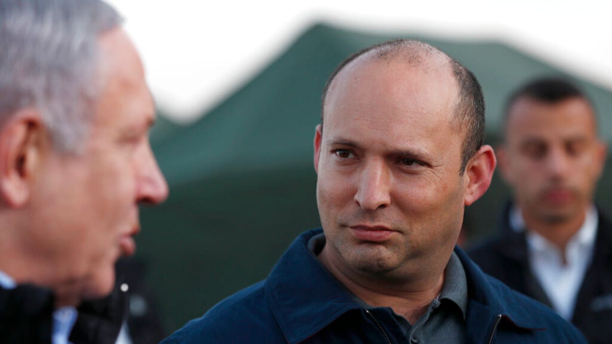 Israeli Prime Minister Benjamin Netanyahu, left, and Defense Minister Naftali Bennett, visit an Israeli army base in the Golan Heights, on the Israeli-Syrian border, Sunday, Nov. 24, 2019. (Atef Safadi/Pool via AP)