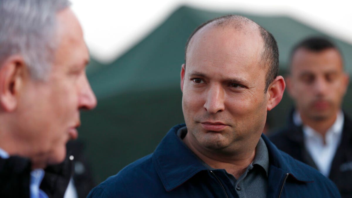 Naftali Bennett looks at Benjamin Netanyahu