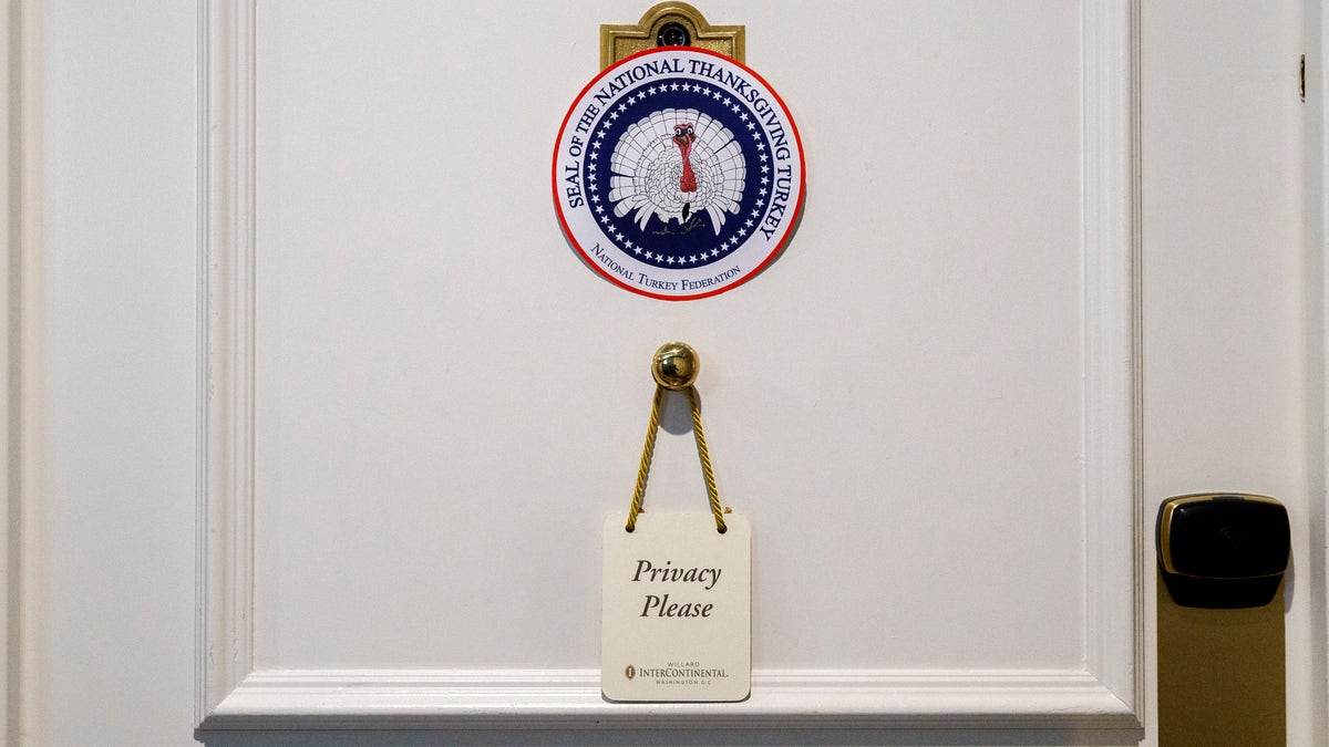 A door has a privacy request hanging on it outside the hotel room where two turkeys that will be pardoned by President Donald Trump are staying at the Willard InterContinental Hotel, Monday, Nov. 25, 2019, in Washington. The turkeys will be pardoned by the president during a ceremony at the White House ahead of Thanksgiving. (AP Photo/Jacquelyn Martin)