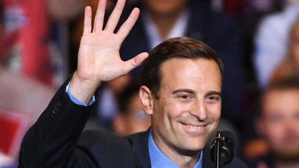 Former Nevada Attorney General and current GOP U.S. Senate candidate Adam Laxalt waves after speaking during a Donald Trump campaign rally at the Las Vegas Convention Center on Sept. 20, 2018, in Las Vegas.