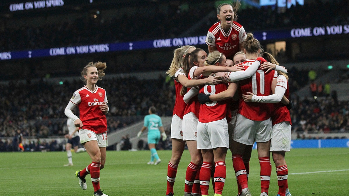 Arsenal celebrate after Vivanne Miedema scores her sides second goal of the match against Tottenham Hotspur during their Women's Super League soccer match at the Tottenham Hotspur Stadium in London, Sunday Nov. 17, 2019. The match drew a record crowd of 38,262 for the competition on Sunday when Arsenal claimed a 2-0 victory at Tottenham. (Zac Goodwin/PA via AP)