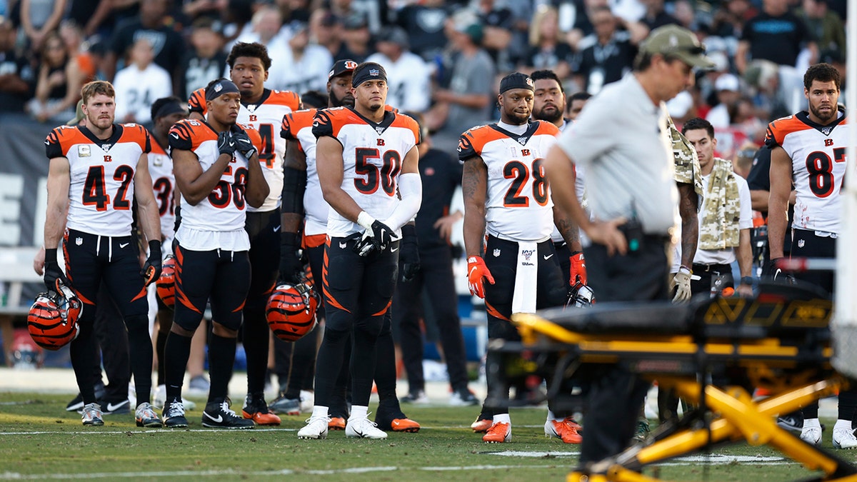 The Cincinnati Bengals look on as Bengals wide receiver Auden Tate is carried off the field after an injury during the second half of an NFL football game against the Oakland Raiders in Oakland, Calif., Sunday, Nov. 17, 2019. (AP Photo/D. Ross Cameron)