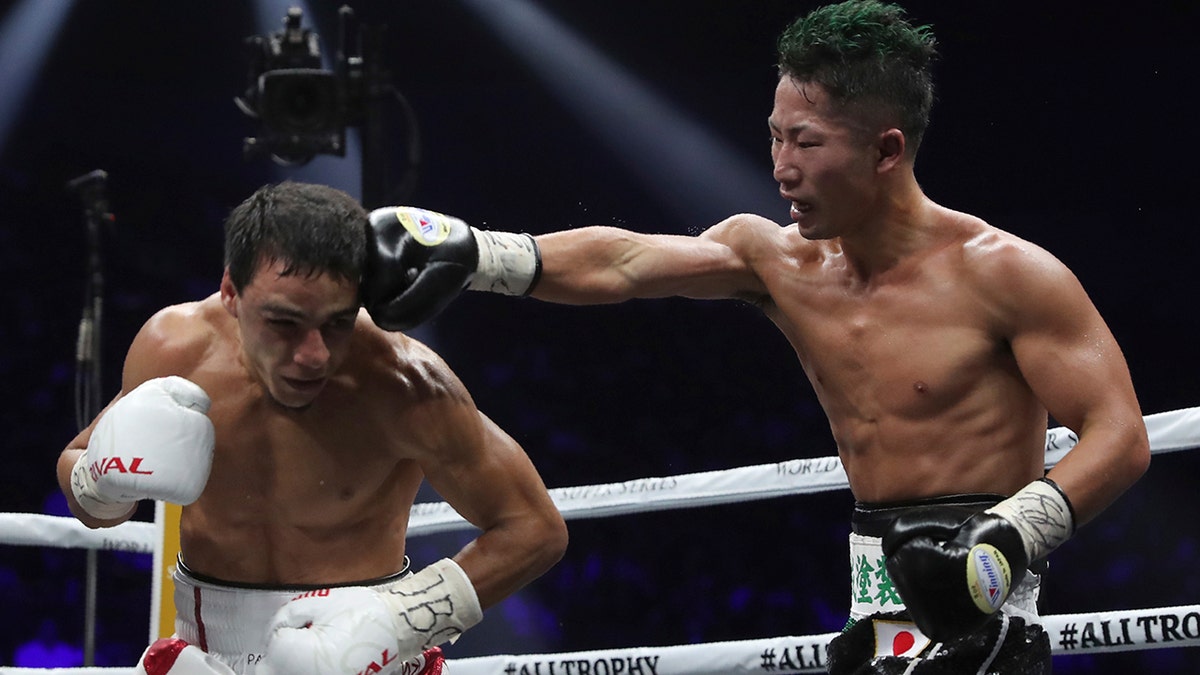 Japan's Takuma Inoue, right, sends a right to France's Nordine Oubaali in the 12th round of their WBC world bantamweight title match in Saitama, Japan, Thursday, Nov. 7, 2019. Oubaali defeated Inoue by a unanimous decision. (AP Photo/Toru Takahashi)