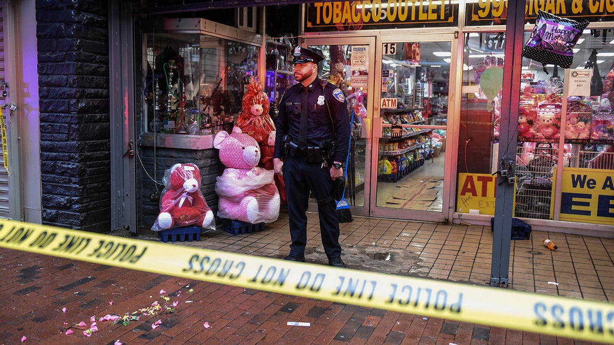 Police officer stands in front of Baltimore business