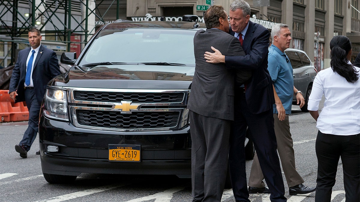 New York Gov. Andrew Cuomo, left, and Mayor Bill de Blasio embrace as they arrive near the scene of an explosion on West 23rd street in Manhattan's Chelsea neighborhood, in New York, Sunday, Sept. 18, 2016, after an incident that injured passers-by Saturday evening. (AP Photo/Craig Ruttle)