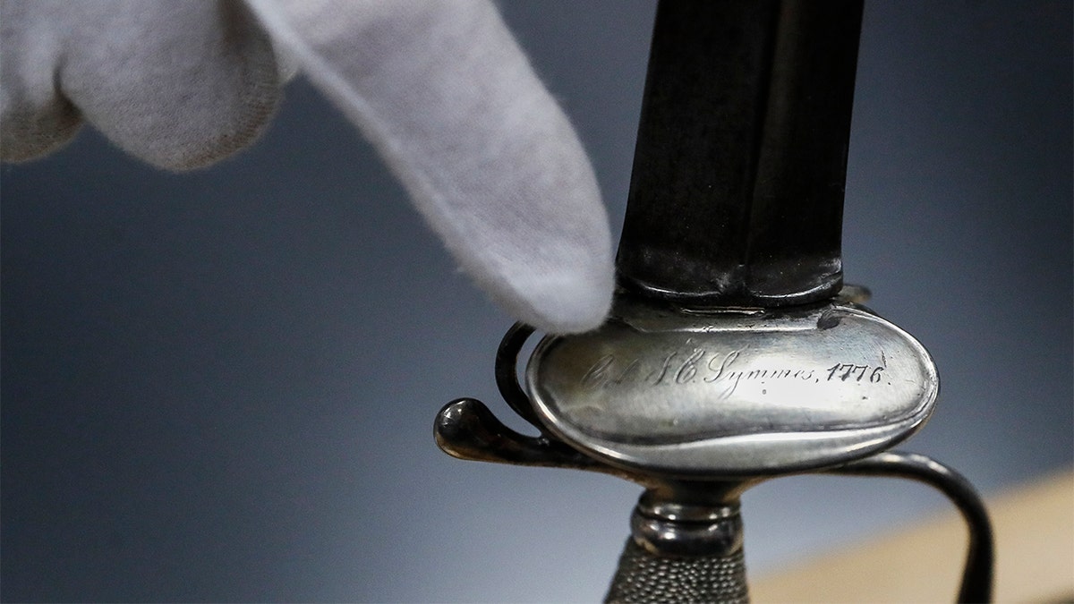 Hamilton County Sheriff Jim Neil points out an engraving that includes the phrase 'J.C. Symmes 1776'. (AP Photo/John Minchillo)