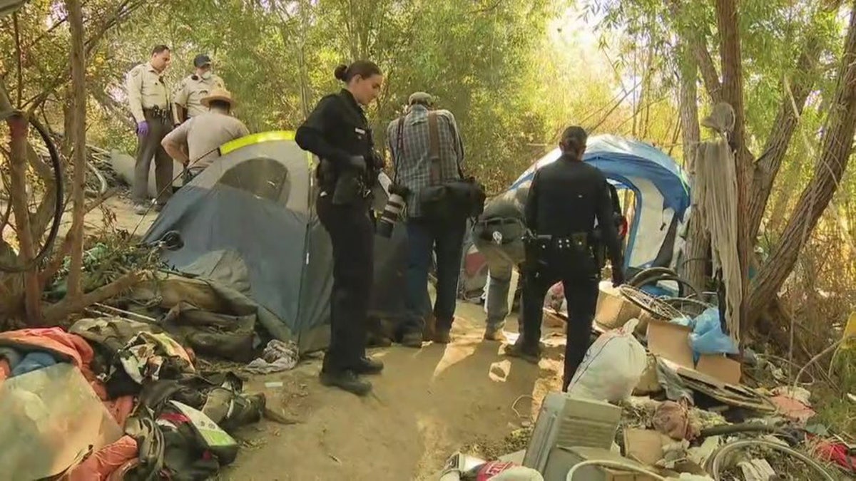 Crews work to dismantle homeless encampment in the Sepulveda Basin Wildlife Reserve on Monday.