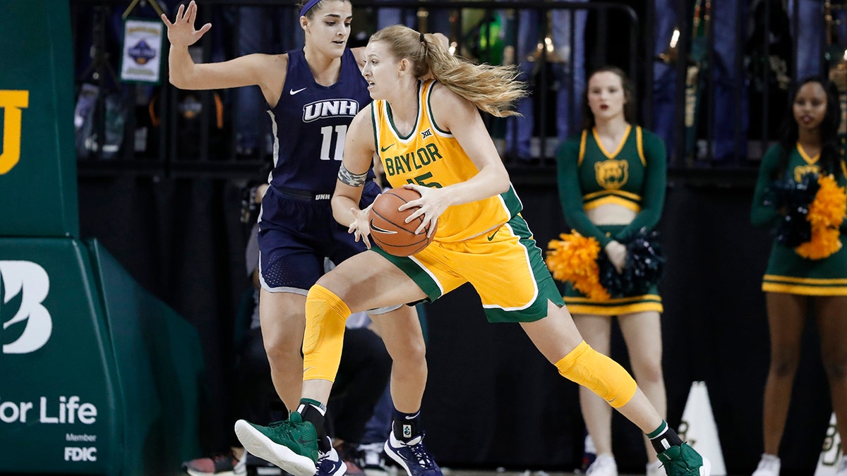 New Hampshire's Ashley Storey (11) defends as Baylor's Lauren Cox (15) works to the basket for a shot in the first half of an NCAA college basketball game in Waco, Texas, Tuesday, Nov. 5, 2019. (AP Photo/Tony Gutierrez)