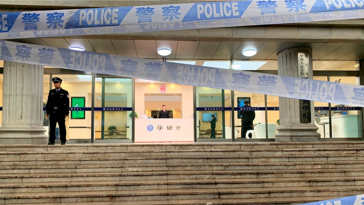 Police stand guard outside the Xingtai Intermediate People's court in Xingtai county, north China's Hebei province Thursday, Nov. 7, 2019.