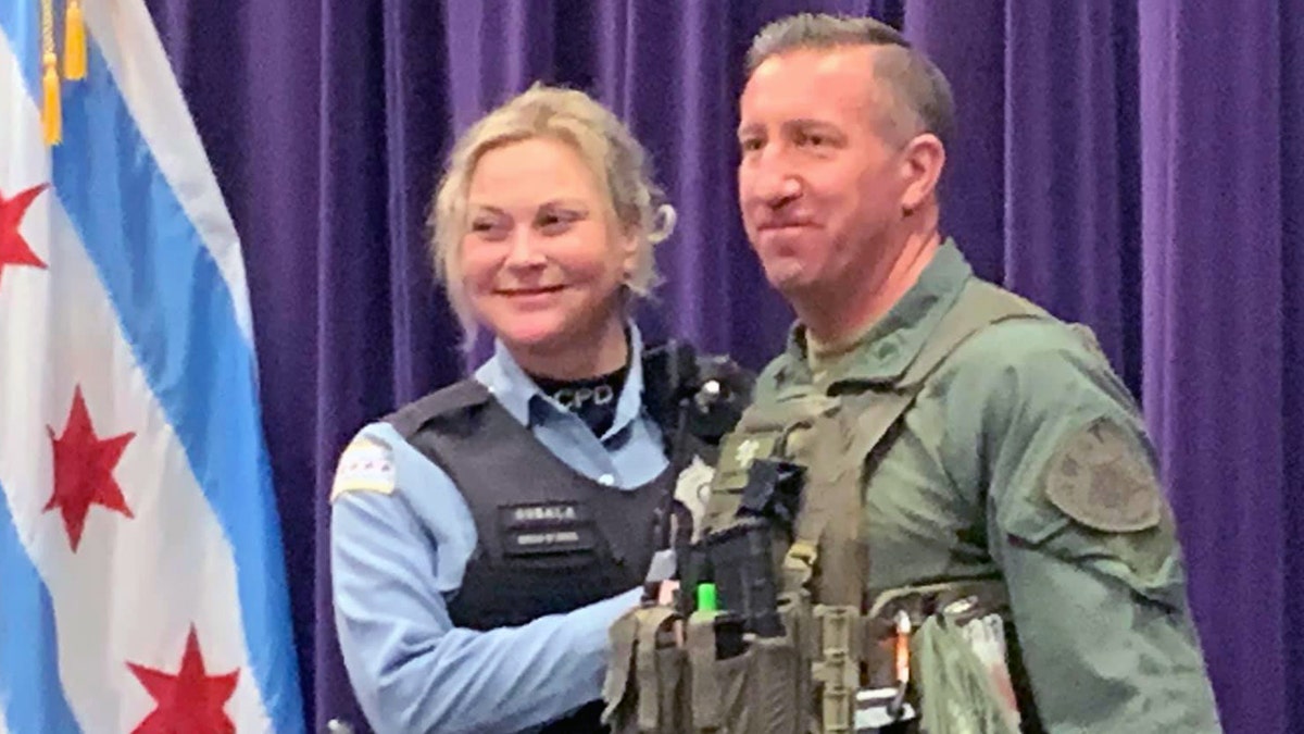 Chicago Police Officer Erin Gubala with SWAT Sgt. Mike Nowacki got engaged Sunday after Nowacki ran the Hot Chocolate 15k in full gear and reviving another runner.
