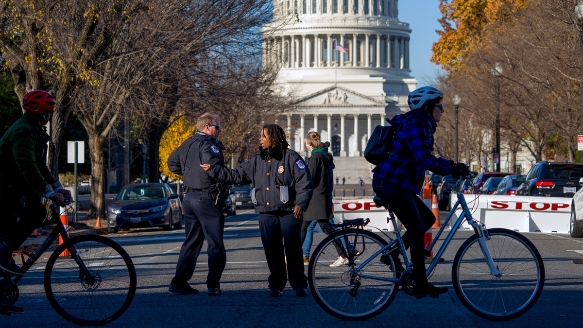 Officers direct passerby to keep at a safe distance from the U.S. Capitol Tuesday. (AP Photo/J. Scott Applewhite)