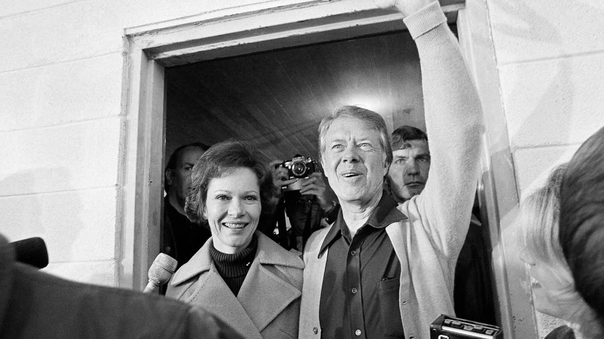 Democratic presidential candidate Jimmy Carter and his wife, Rosalynn, depart the Plains, Ga., polling place, Nov. 2, 1976. The candidate was the fifth person to vote in his precinct. (AP Photo)