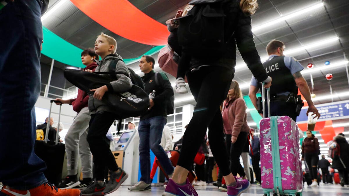 Travelers are seen passing through Chicago's O'Hare International Airport amid one of the busiest travel periods of the year.