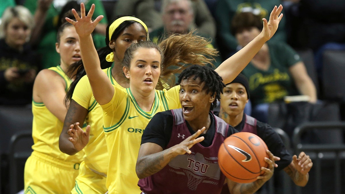 Texas Southern's Ciani Cryor, front, looks for an open teammate while under pressure from Oregon's Erin Boley, left, Ruthy Hebard and Taylor Chavez during the first quarter of an NCAA college basketball game in Eugene, Ore., Saturday, Nov. 16, 2019. (AP Photo/Chris Pietsch)