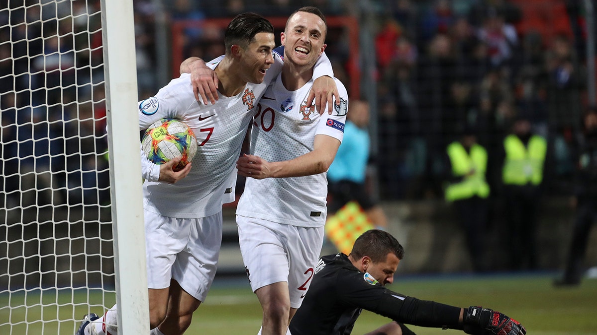 Portugal's Cristiano Ronaldo, left, celebrates with his teammate Diogo Jota after he scored his side's second goal during the Euro 2020 group B qualifying soccer match between Luxembourg and Portugal at the Josy Barthel stadium in Luxembourg, Sunday, Nov. 17, 2019. (AP Photo/Francisco Seco)