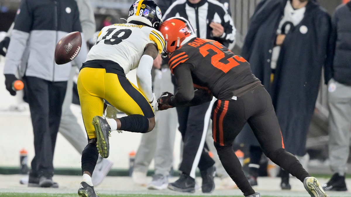 Cleveland Browns strong safety Damarious Randall (23) hits Pittsburgh Steelers wide receiver Diontae Johnson (18) during the second half of an NFL football game Thursday, Nov. 14, 2019, in Cleveland. Randall was called for unnecessary roughness and was ejected. 