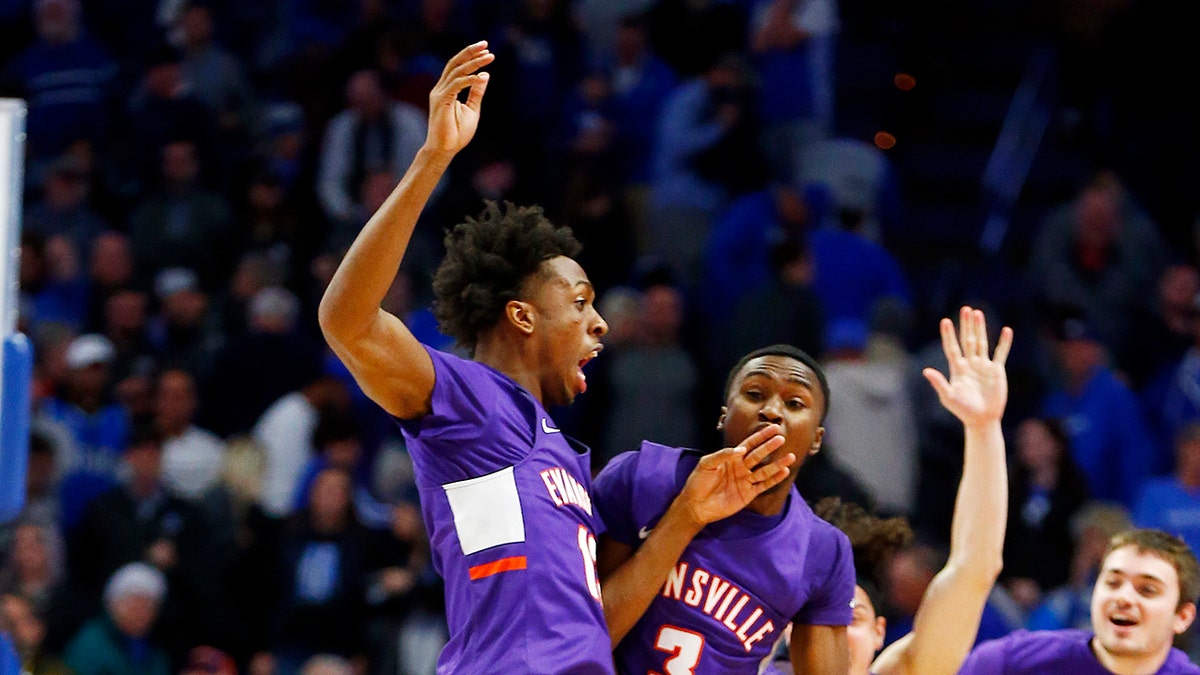 Evansville's DeAndre Williams, top left, and Jawaun Newton (3) celebrate after the team's NCAA college basketball game against Kentucky in Lexington, Ky., Tuesday, Nov. 12, 2019. Evansville won 67-64. (AP Photo/James Crisp)