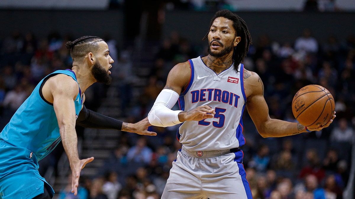 Detroit Pistons guard Derrick Rose, right, looks to pass the ball as Charlotte Hornets forward Cody Martin defends during the second half of an NBA basketball game in Charlotte, N.C., Friday, Nov. 15, 2019. Charlotte won 109-106. (AP Photo/Nell Redmond)