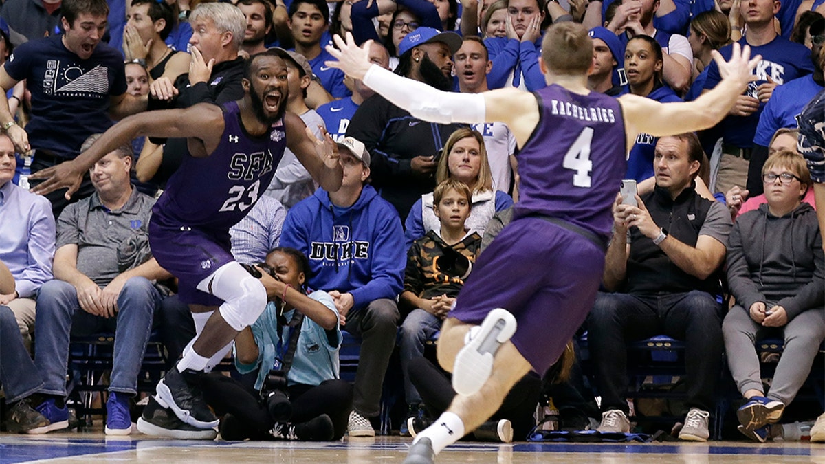 Stephen F. Austin forward Nathan Bain (23) and guard David Kachelries (4) celebrated Bain's game winning basket against Duke in overtime on Tuesday. (AP Photo/Gerry Broome)