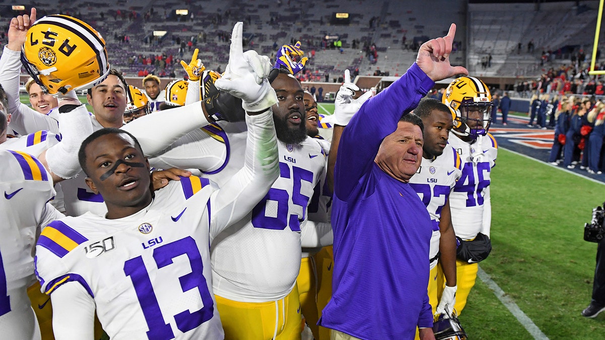 LSU coach Ed Orgeron and players celebrate after an NCAA college football game against Mississippi in Oxford, Miss., Saturday, Nov. 16, 2019. No. 1 LSU won 58-37. (AP Photo/Thomas Graning)