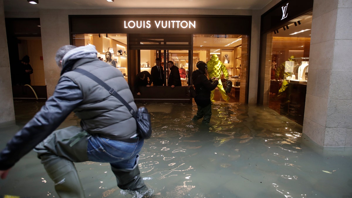 Flood water reaches a luxury shop in Venice, Italy, Sunday, Nov. 17, 2019.