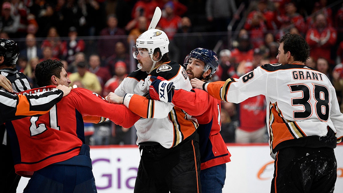 Washington Capitals right wing Garnet Hathaway (21) scuffles with Anaheim Ducks defenseman Erik Gudbranson, second from left, during the second period of an NHL hockey game, Monday, Nov. 18, 2019, in Washington. Also seen is Capitals center Chandler Stephenson, second from right, and Ducks center Derek Grant (38). (AP Photo/Nick Wass)