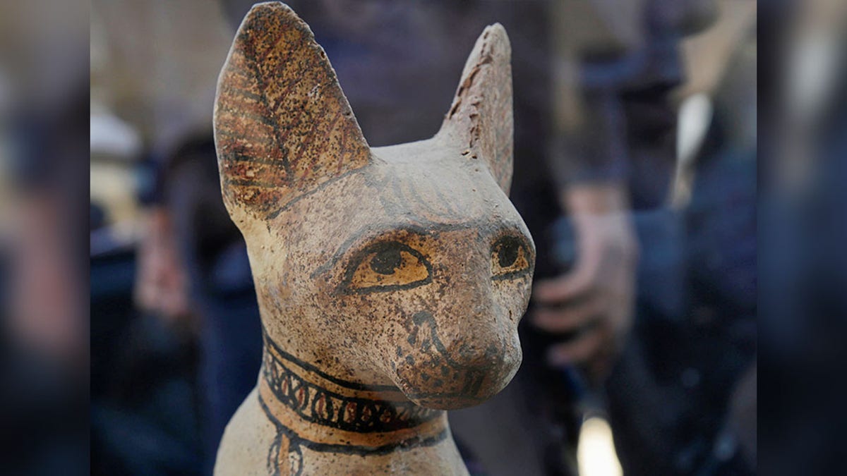 A cat statue that was found inside a cache, at the Saqqara area near its necropolis is pictured in Giza, Egypt, Saturday. (REUTERS/Hayam Adel)