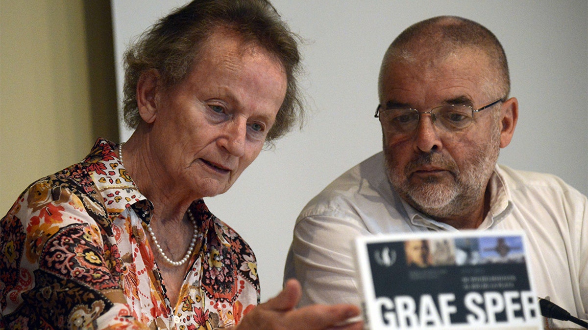 German Inge Nedden (L), daughter of German WWII battleship Graf Spee's captain Hans Langsdorff, and Uruguayan writer Daniel Acosta y Lara (R) present his and Federico Leicht's book "Graf Spee, from Wilhelmshaven to the River Plate", during the commemoration of the 75th anniversary of the Battle of the River Plate in Montevideo on December 13, 2014.