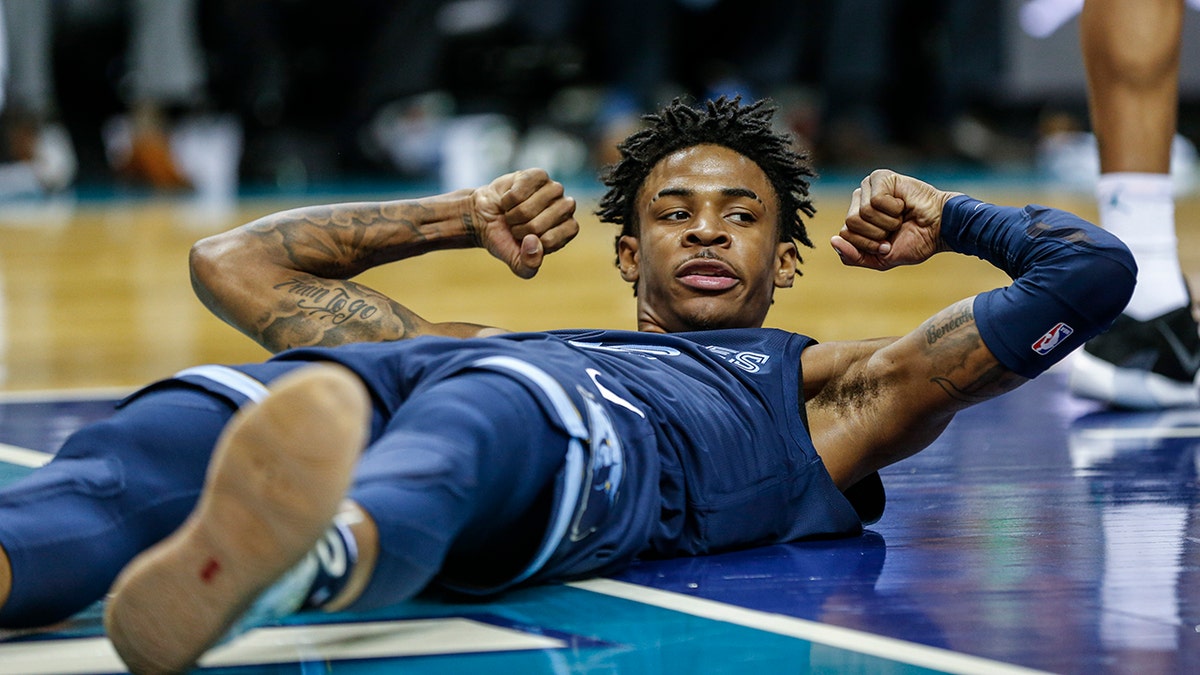 Memphis Grizzlies guard Ja Morant flexes after being fouled in the first half of an NBA basketball game against the Charlotte Hornets in Charlotte, N.C., Wednesday, Nov. 13, 2019. (AP Photo/Nell Redmond)