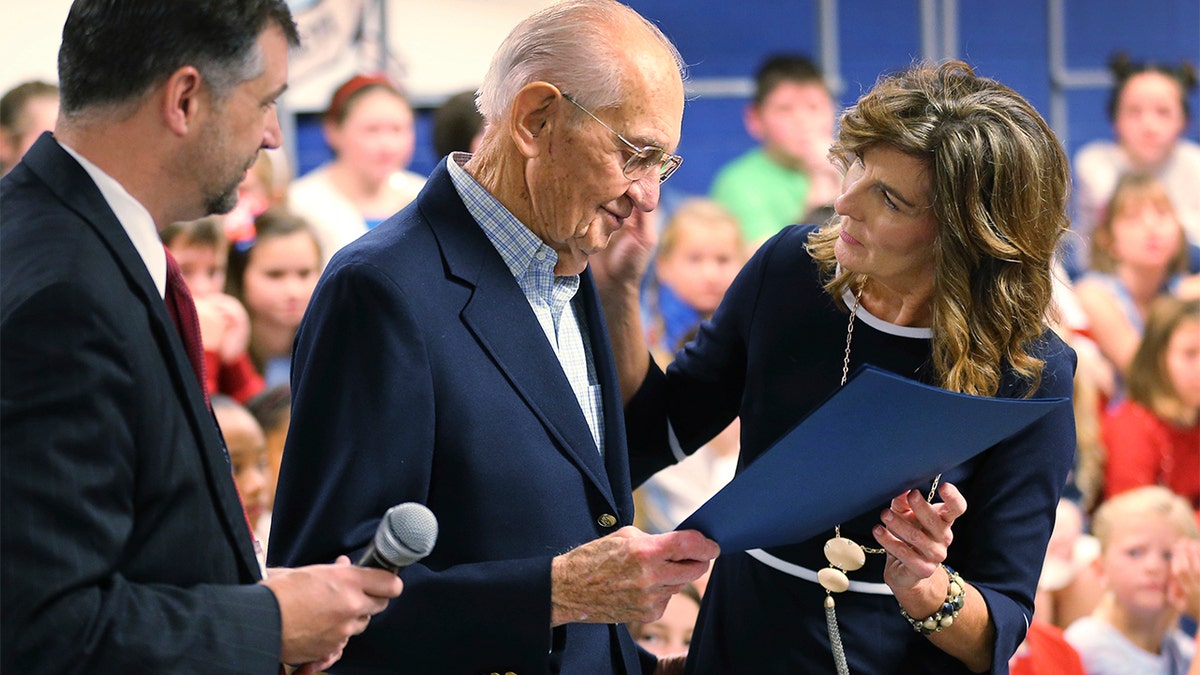 World War II veteran James Wallace Yarbrough, center, was presented an honorary diploma by school principal Lisa Thompson, right, and Hanover school superintendent Dr. Michael Gill, left.  (Dean Hoffmeyer/Richmond Times-Dispatch via AP)