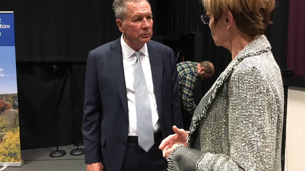Former Ohio Gov. John Kasich speaks to an audience member after a book tour event at the University of New Hampshire in Durham, N.H., on Nov. 7, 2019.