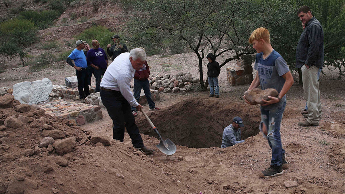 Men dug a mass grave for some of the victims who were killed in Monday's Mexican cartel ambush. (AP Photo/Marco Ugarte)
