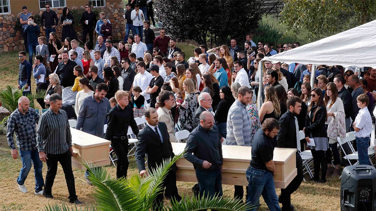 Men carried the remains of Dawna Ray Langford and her sons in handmade pine coffins. (AP Photo/Marco Ugarte)