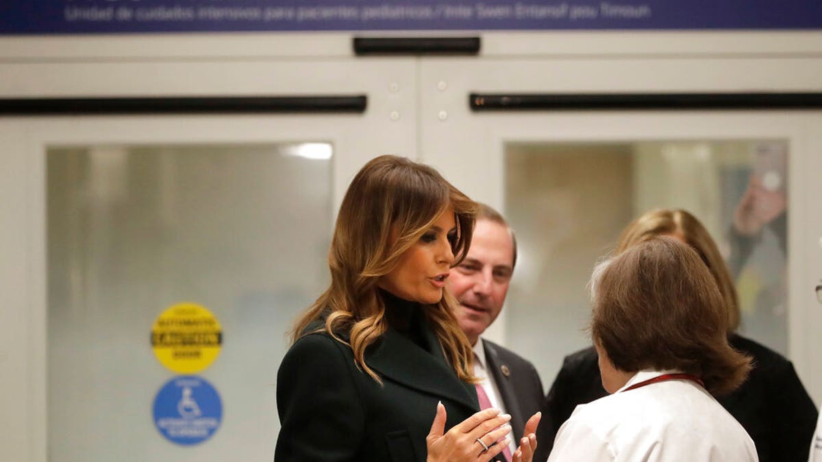First lady Melania Trump, left, speak with pediatrician Eileen Costello, front right, as U.S. Secretary of Health and Human Services Alex Azar, behind center, looks on during a visit to Boston Medical Center, in Boston, Wednesday, Nov. 6, 2019. (AP Photo/Steven Senne, Pool)