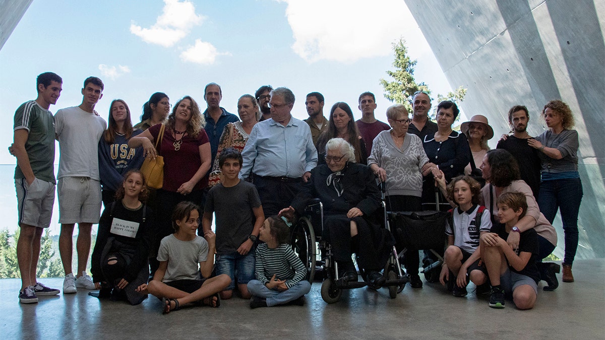 Melpomeni Dina, center right, posing for a group photo during the reunion at the Yad Vashem Holocaust memorial in Jerusalem.