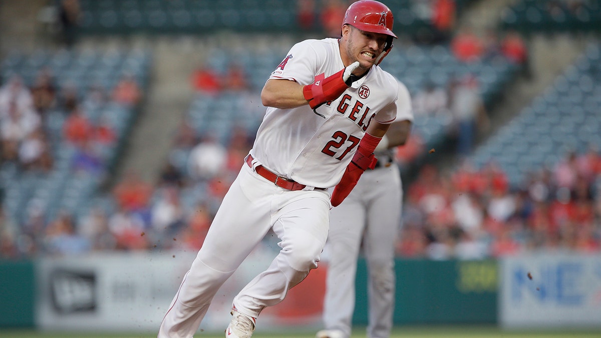 FILE - In this July 30, 2019, file photo, Los Angeles Angels' Mike Trout rounds second to advance to third from first on a single by Shohei Ohtani against the Detroit Tigers during the first inning of a baseball game in Anaheim, Calif. Trout was having another spectacular year for the Angels when right foot problems ended his season early. He did not play after Sept. 7 and was limited to 134 games. (AP Photo/Alex Gallardo, File)