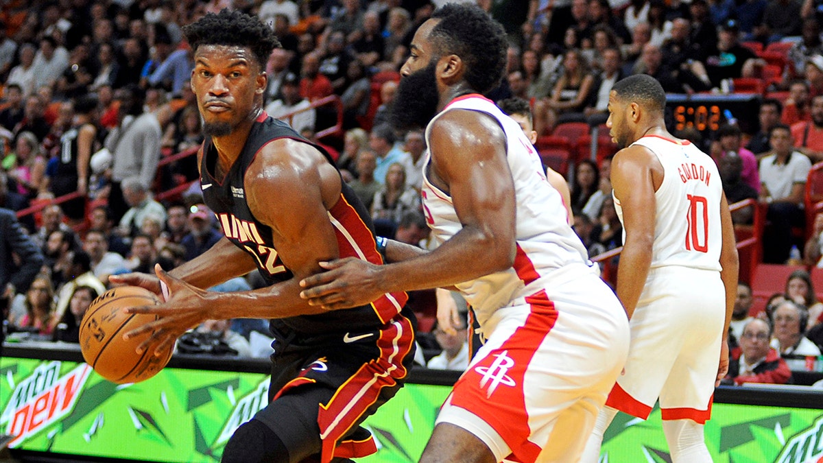 Miami Heat guard Jimmy Butler, left, drives against Houston Rockets guard James Harden during the first half of an NBA basketball game, Sunday, Nov. 3, 2019, in Miami. (AP Photo/Gaston De Cardenas)