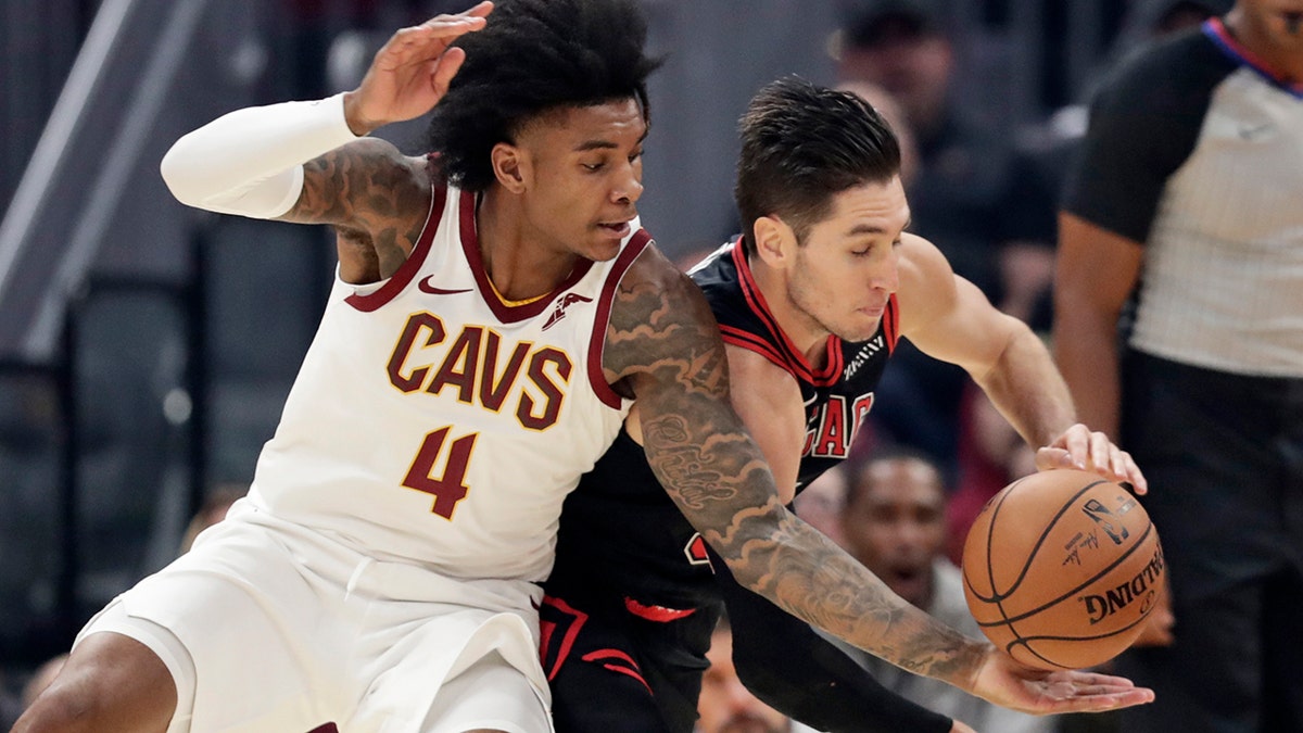 Cleveland Cavaliers' Kevin Porter Jr. (4) and Chicago Bulls' Ryan Arcidiacono (51) compete for the ball during the first half of an NBA basketball game Wednesday, Oct. 30, 2019, in Cleveland. (AP Photo/Tony Dejak)