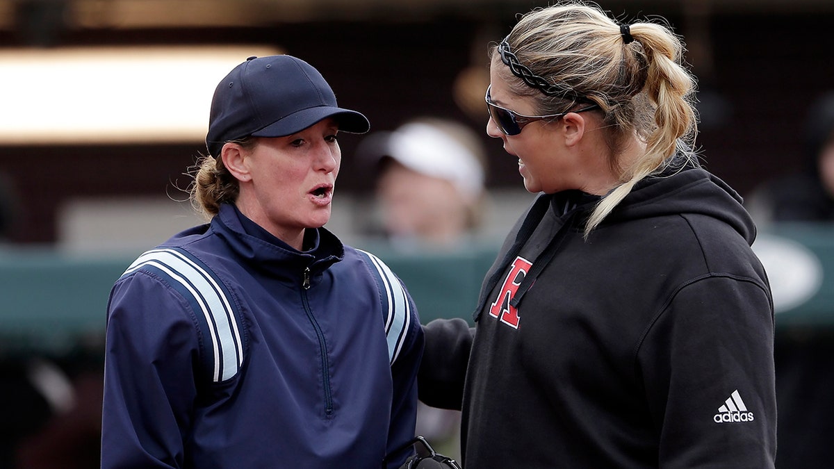 Rutgers head coach Kristen Butler, right, argues a call with the home plate umpire during an NCAA softball game against Texas A&M in College Station, Texas, on Feb. 16, 2019.