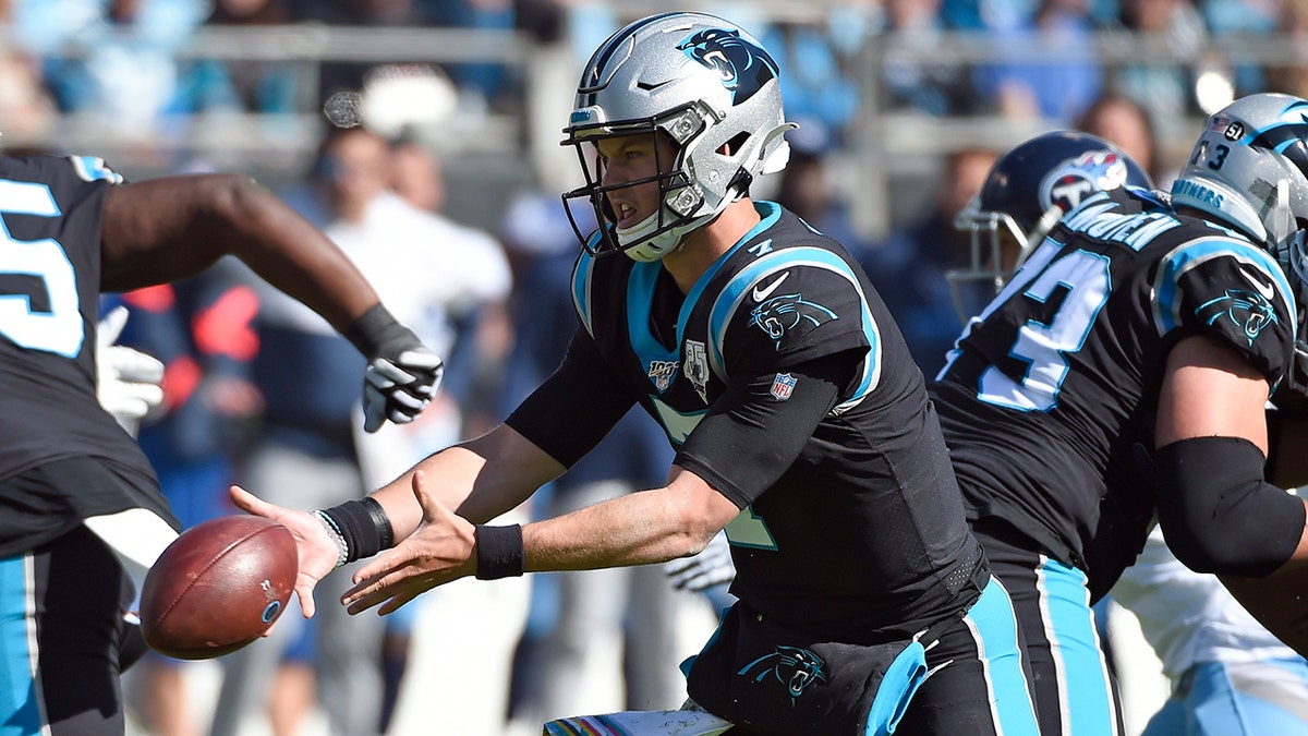 Carolina Panthers quarterback Kyle Allen tosses the ball during the first half of an NFL football game against the Tennessee Titans in Charlotte, N.C., Sunday, Nov. 3, 2019. (AP Photo/Mike McCarn)