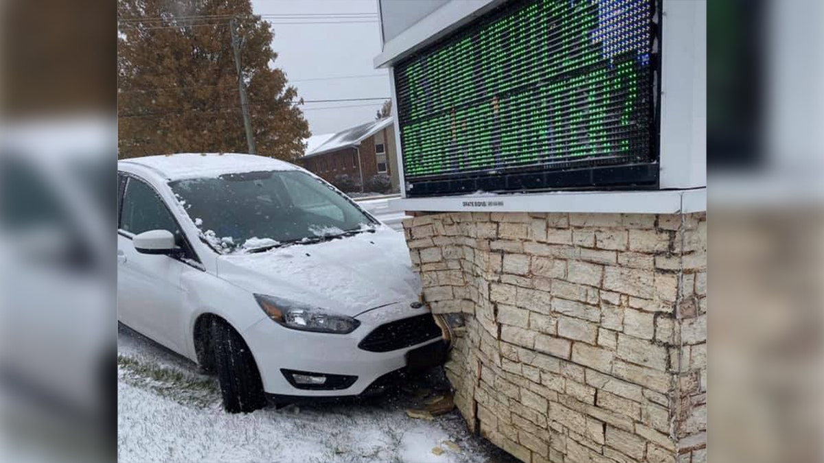 A car crashed into a sign with an electronic display board that read "Is your vehicle ready for winter?" as snow fell across the Midwest on Monday. 