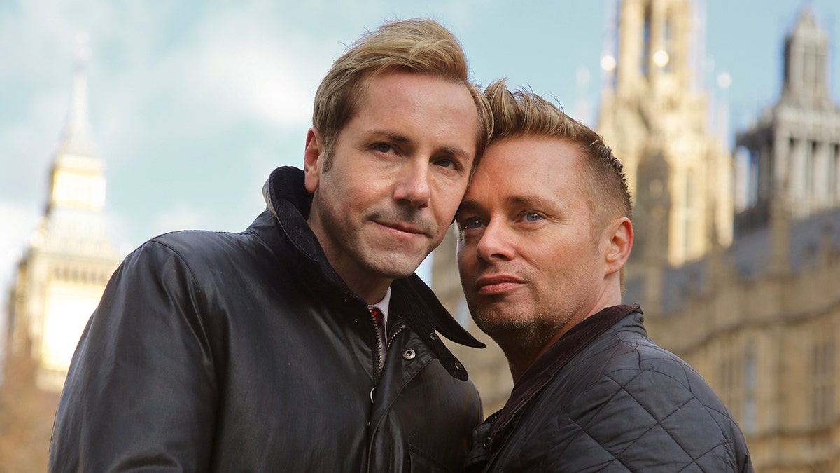 Tony, left, and Barrie Drewitt-Barlow, of Chelmsford, Essex pose near the Houses of Parliament in London in February 2013. 