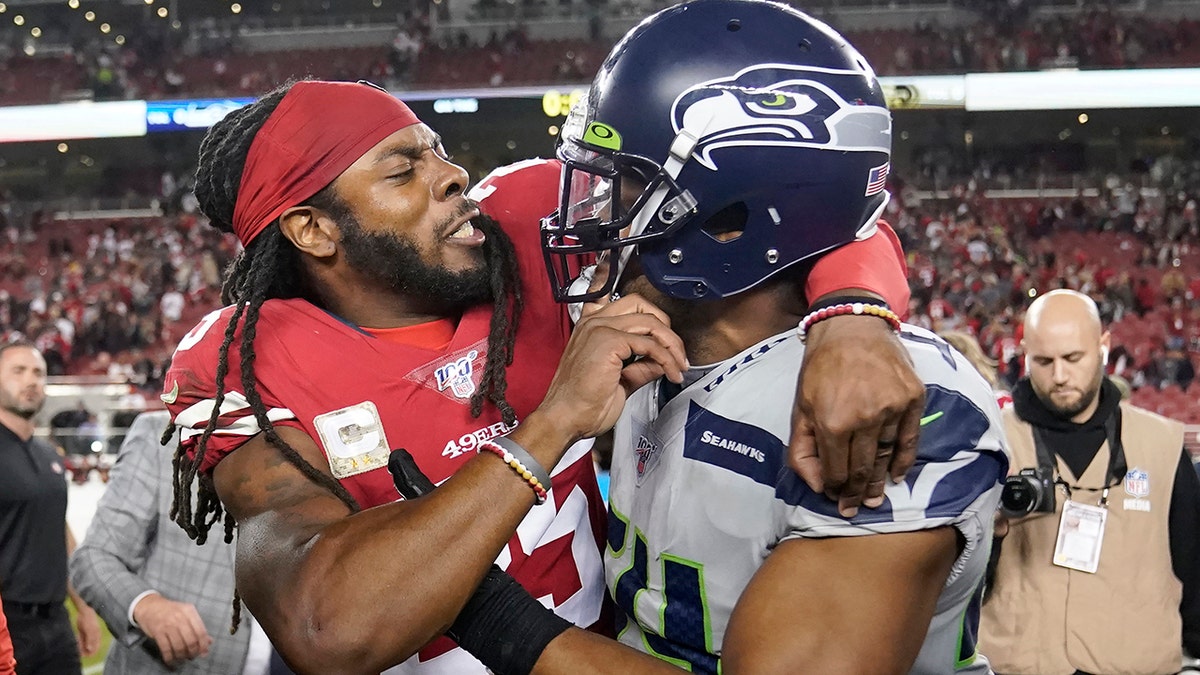 San Francisco 49ers cornerback Richard Sherman, left, hugs Seattle Seahawks middle linebacker Bobby Wagner after an NFL football game in Santa Clara, Calif., Monday, Nov. 11, 2019. The Seahawks won 27-24 in overtime.