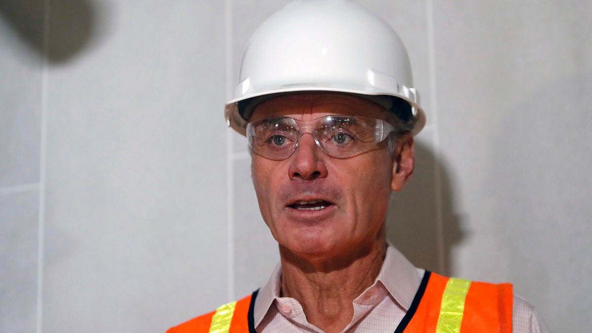 Baseball Commissioner Rob Manfred speaks to the media during a tour of the new under construction Texas Rangers stadium in Arlington, Texas, Tuesday, Nov. 19, 2019. Manfred hopes the investigation into sign stealing by the Houston Astros will be completed by next season and says he has broad authority to impose discipline beyond fines, the loss of amateur draft picks and taking away international signing bonus pool allocation. (AP Photo/LM Otero)