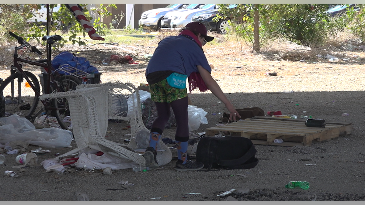 People living in camps under SH 71 spent Monday morning gathering their things ahead of a scheduled cleanup by Texas Department of Transportation.